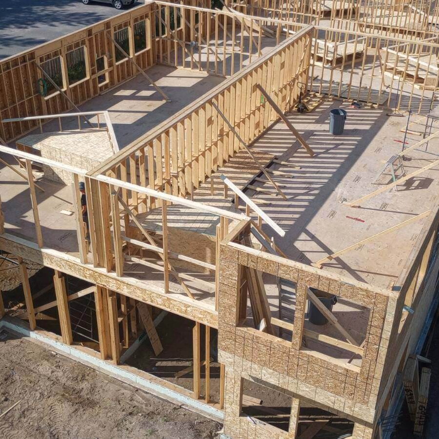 An overhead shot of an under construction 2 story home that is framed in with no roof